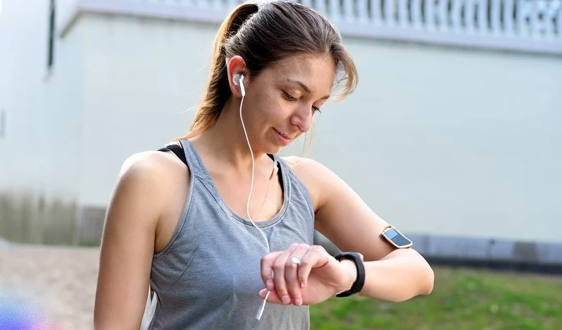 adult girl looking at smartwatch